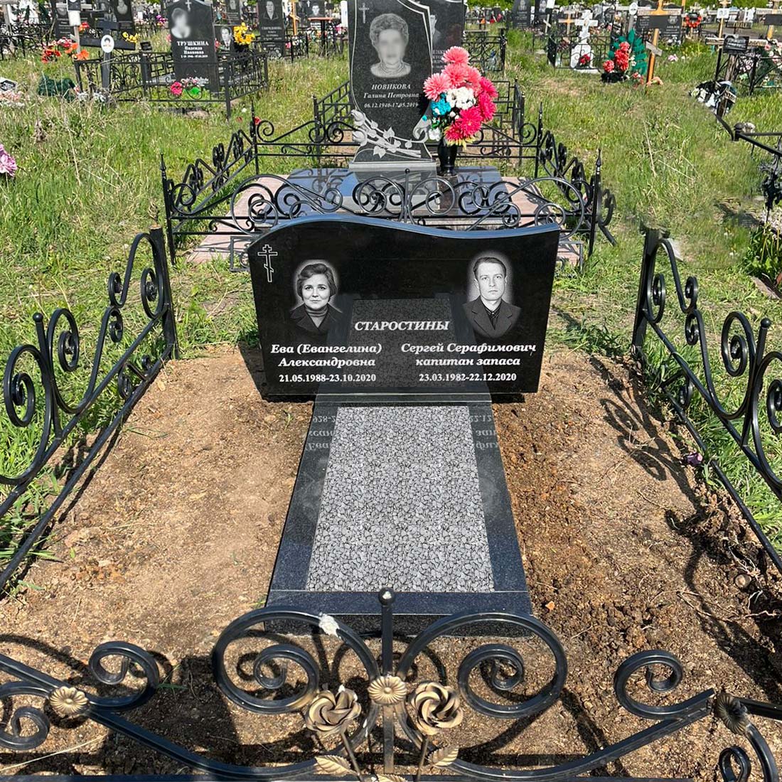 Памятник в форме волны на двоих с двумя портретами